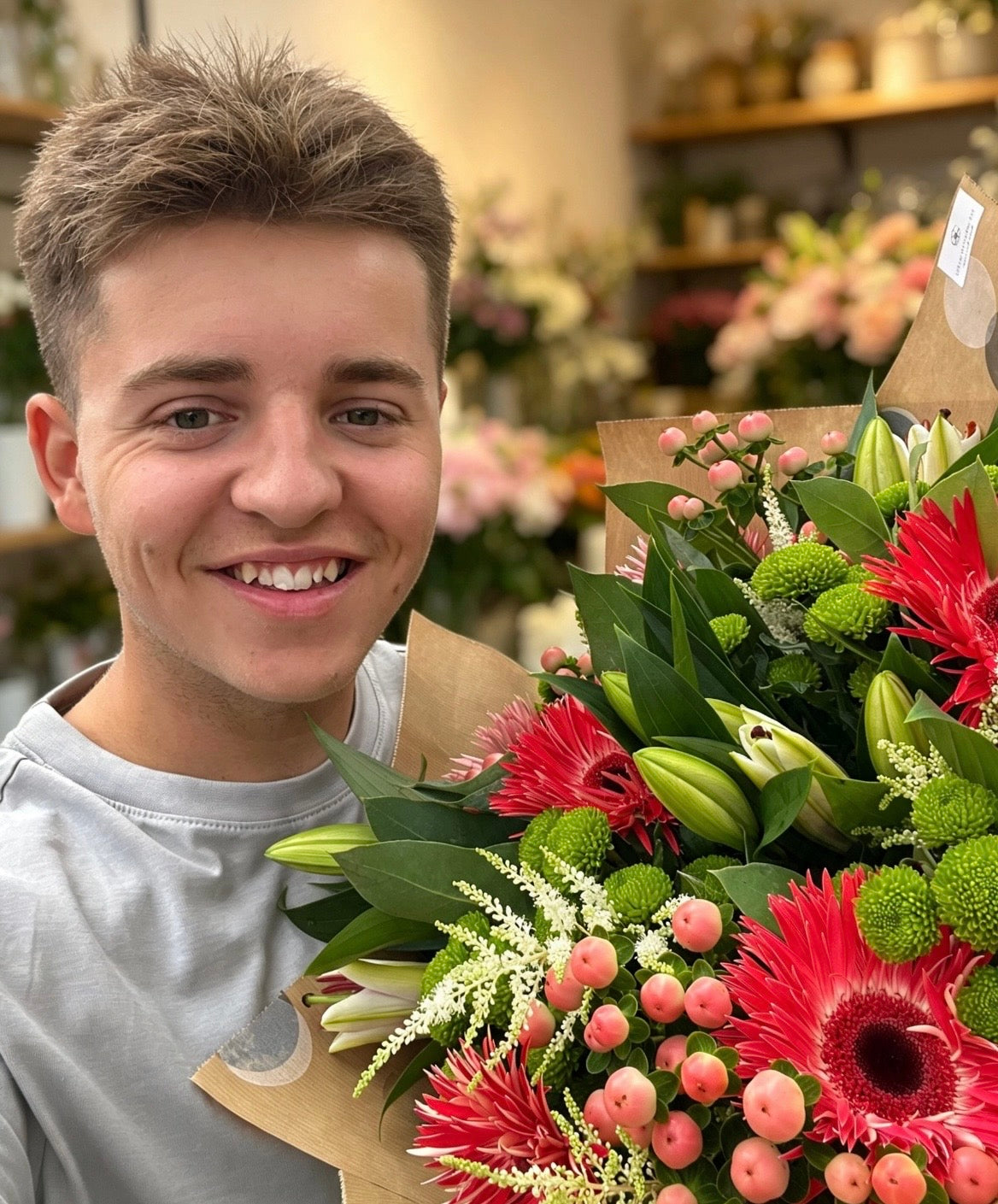 Oliver Barton of The Wild Stem Studio holding a colourful fresh flower bouquet