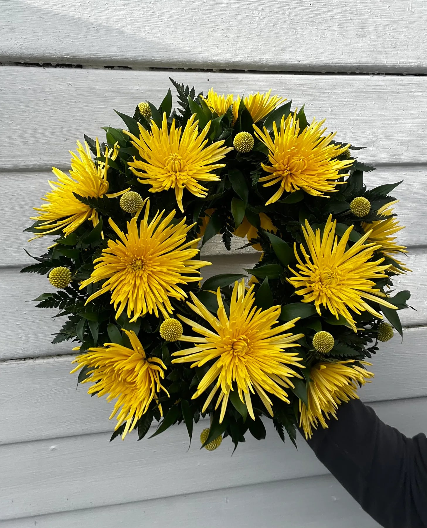 Hand-tied summer bouquet of sunshine-yellow chrysanthemums and green foliage